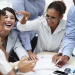 Smiling business people working together at a meeting