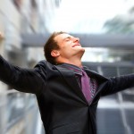 Businessman smiling with arms outstretched