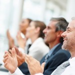 Group of happy business people clapping their hands